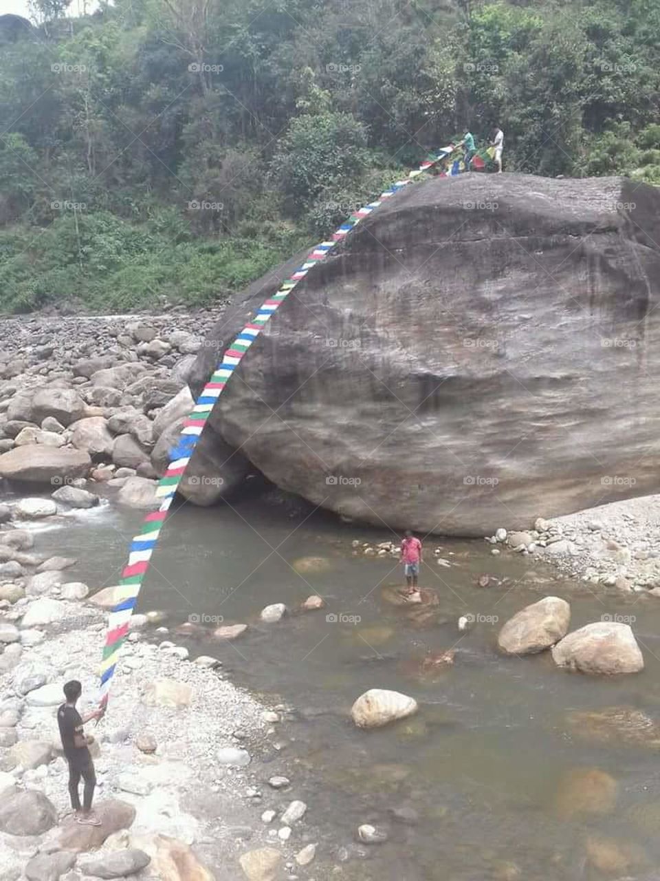 The ritualistic flag connecting the two countries,India and Bhutan. village people supporting cleanindia mission cleaning the river Jaldhaka,which runs in between India and Bhutan.Thus photo is for selling purpise