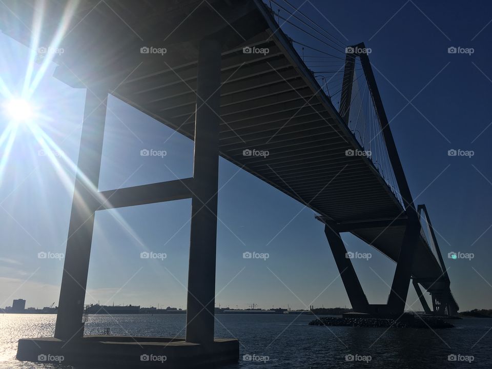 The autumn sun backlights the iconic lines of the Arthur Ravanel Bridge in Charleston harbor.