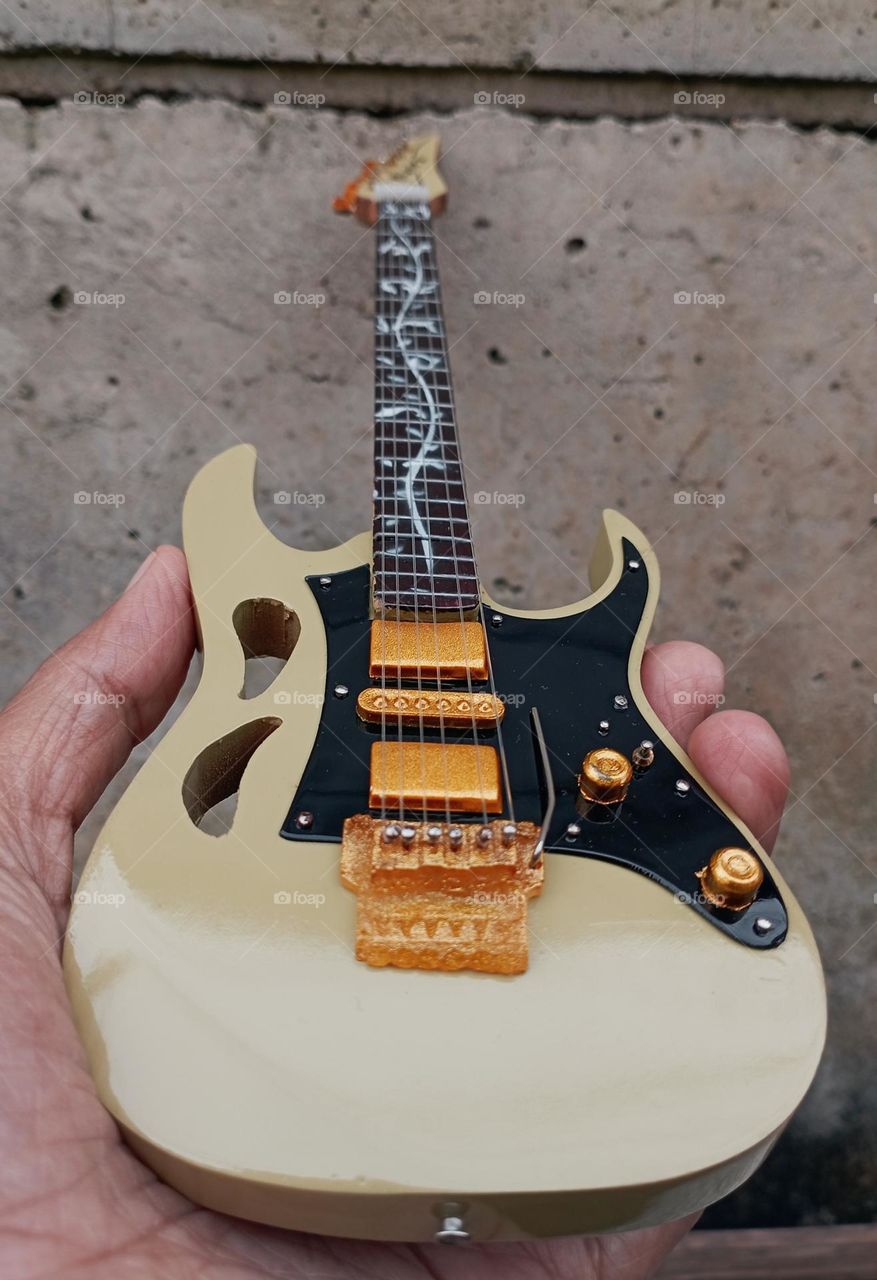 Guitar miniature in a hand