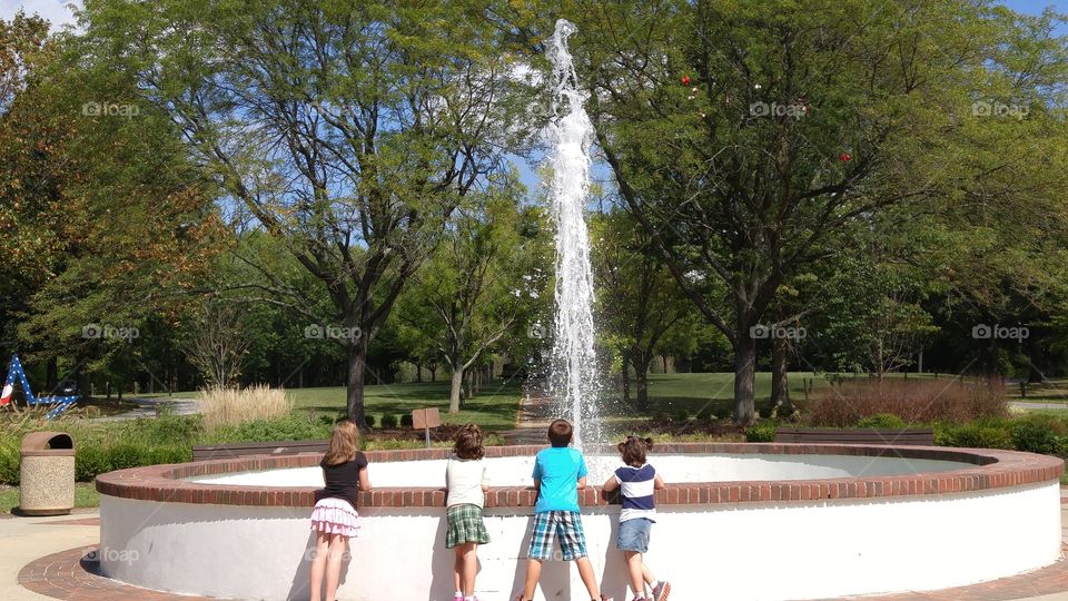 Kids enjoying a fountain in the Summer