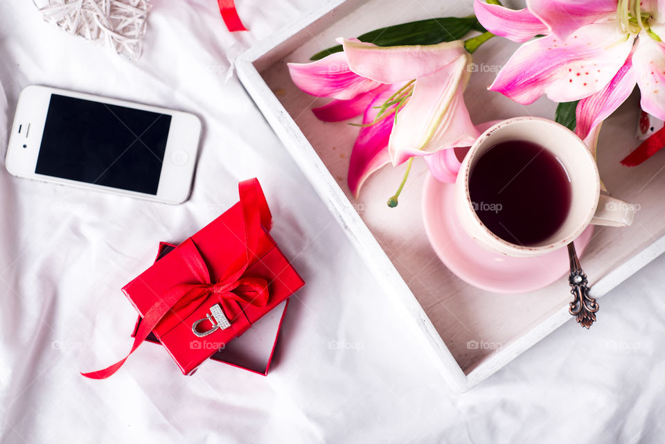 Tea on the tray with flower and gift