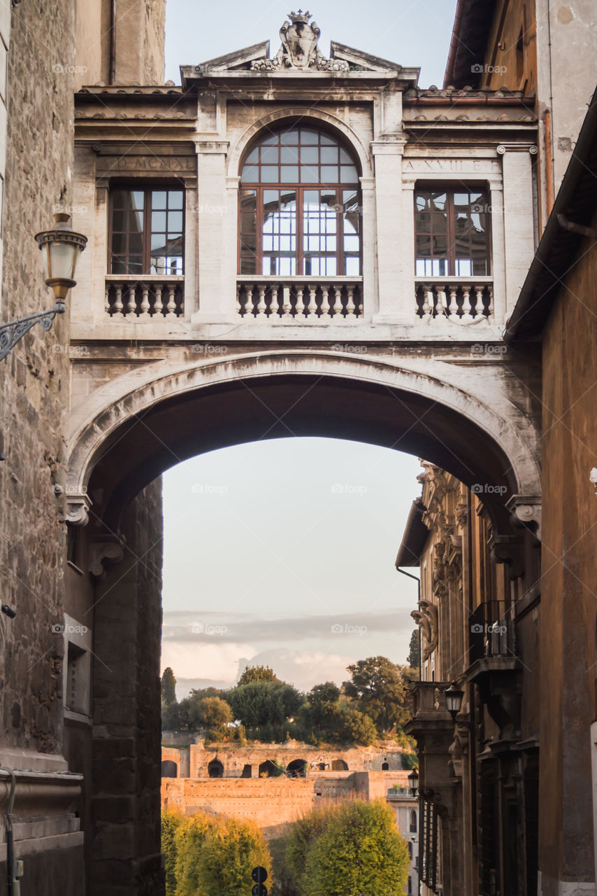Landscape under the pathway between two old buildings in Rome 