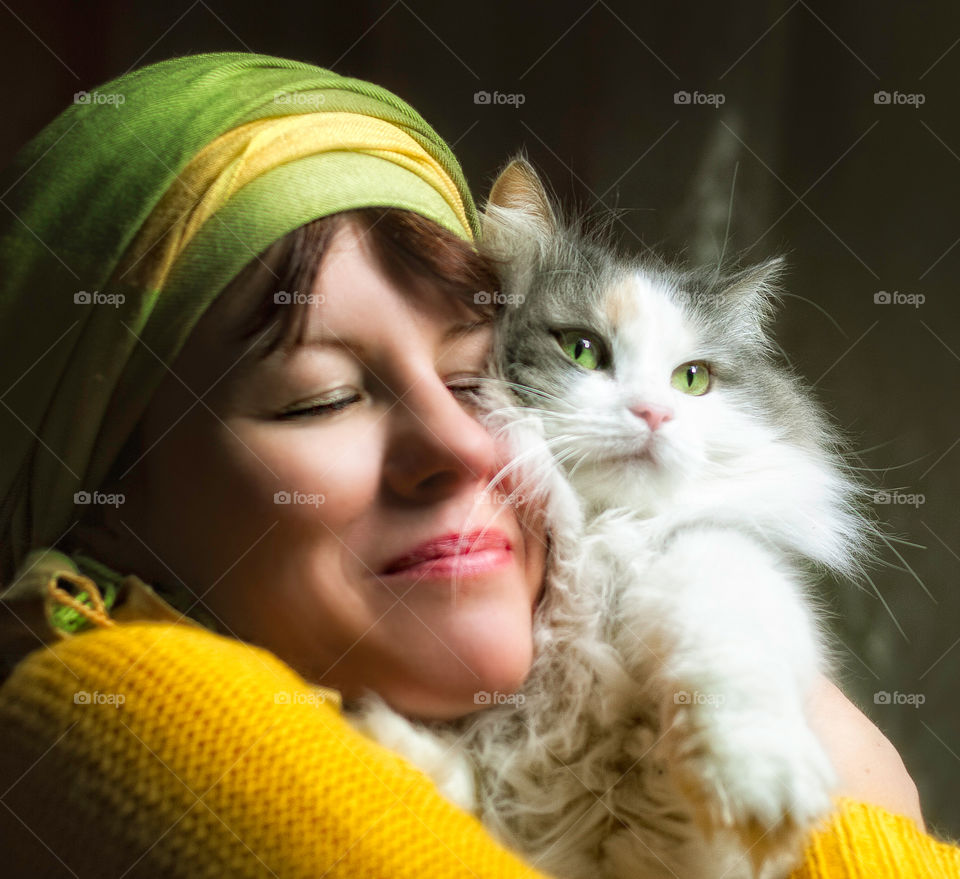 A woman with a cat, hug.