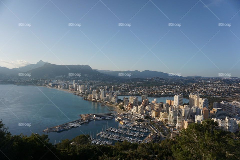 City#view#port#sea#buildings#boats#mountains