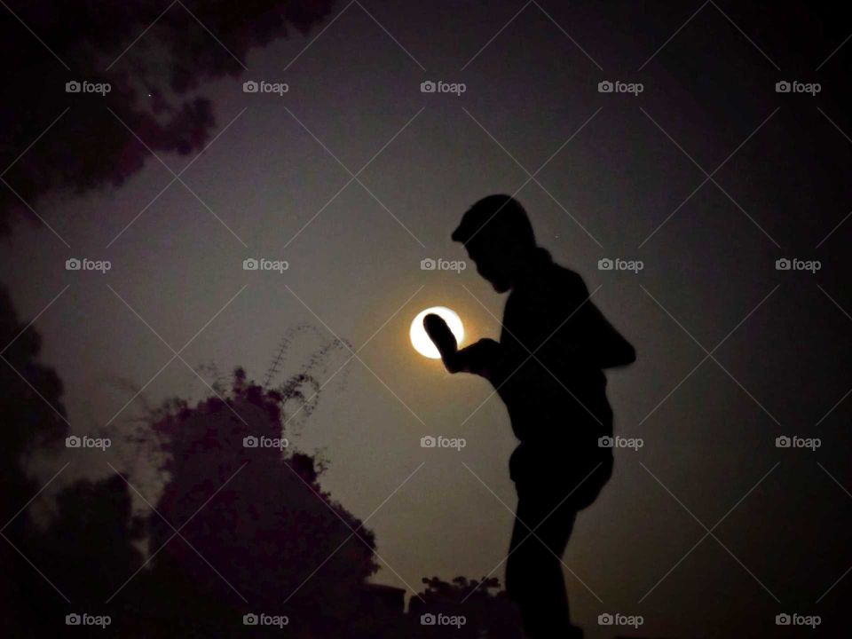 magic night captured during full moon day, playing with moon, hitting like football, enjoying moment, full moon light like a sunny day,