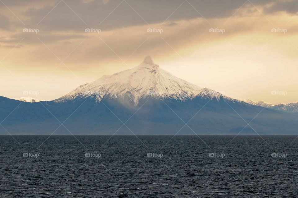 A view of the snow capped peaks of the Andes Mountains while sailing to Puerto Montt, Chile.