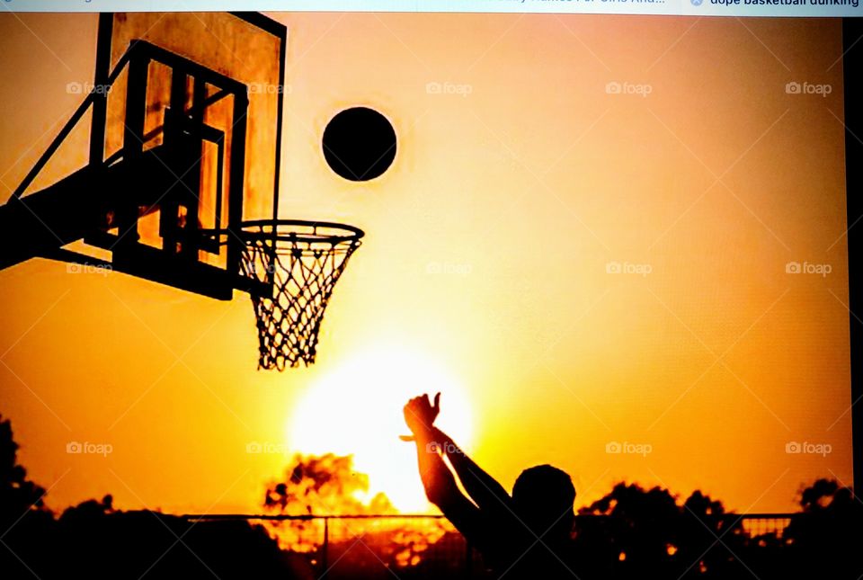 Playing basketball at sunset