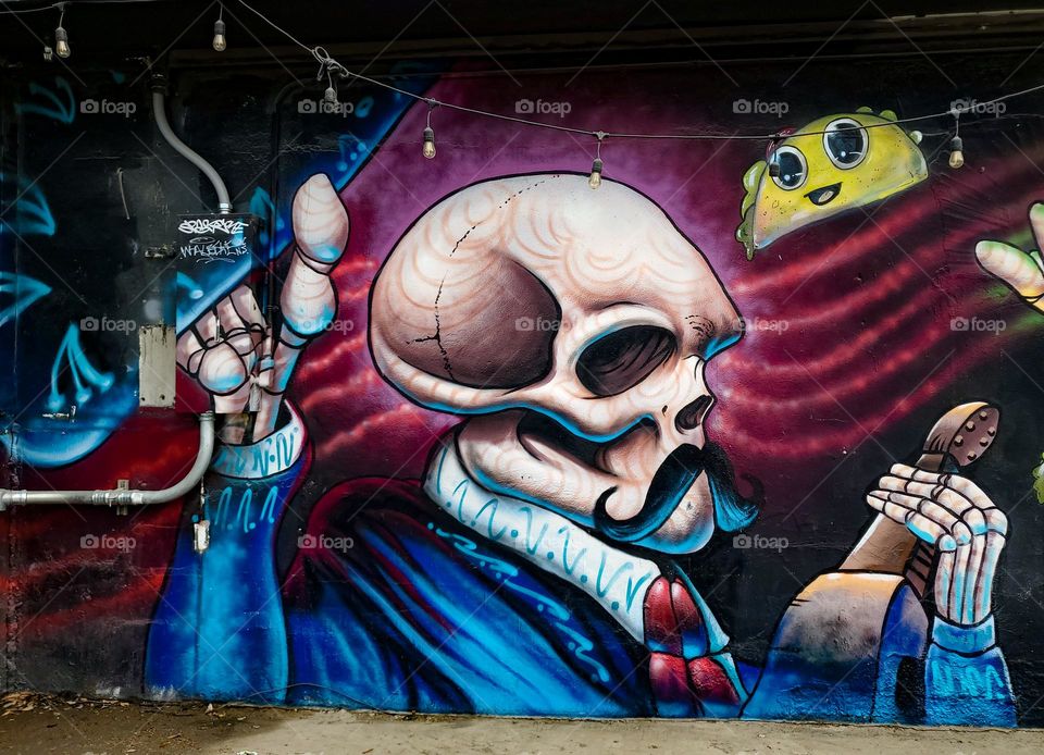 Street art celebrating Dia De Los Muertos/ Day of the Dead.  A Mexican cultural tradition of remembering and celebrating those that have passed.  The art depicts dead Mexican culture musicians.