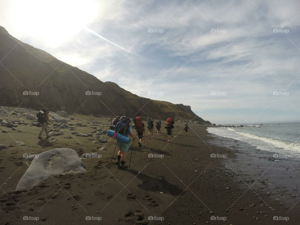 Beach backpacking. 13 of us in a line on the beach