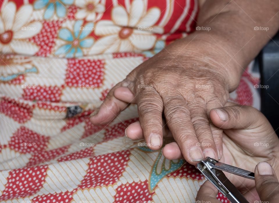 
Granddaughter is cutting grandma’s nail