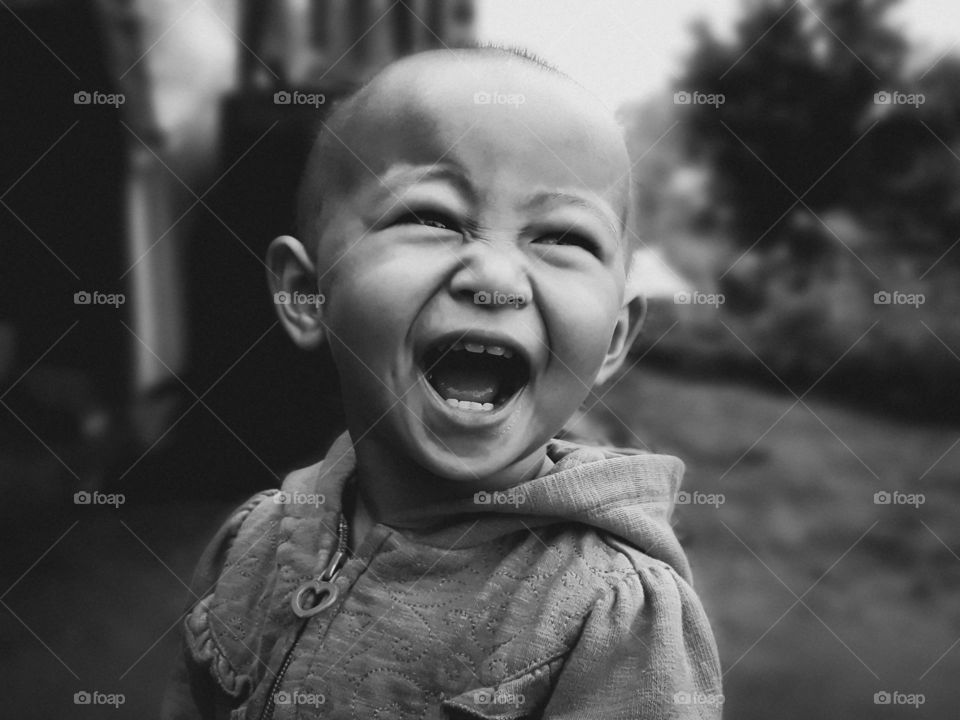 Captured the innocence and happiness of a young kid in black and white. Portrait photography.