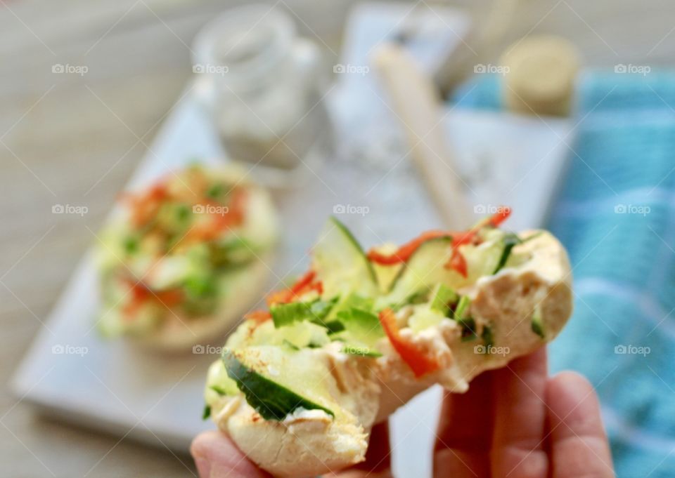 Salmon spread with thinly sliced cucumber, red pepper, and green onion on toasted bagel 🥯