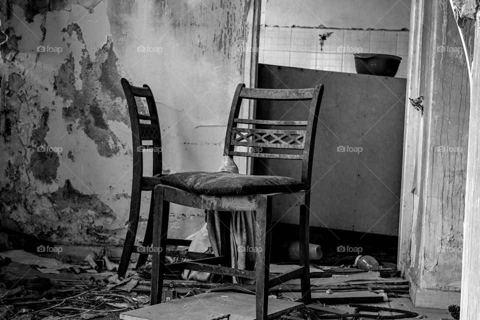 two chairs in the broken house in black and white