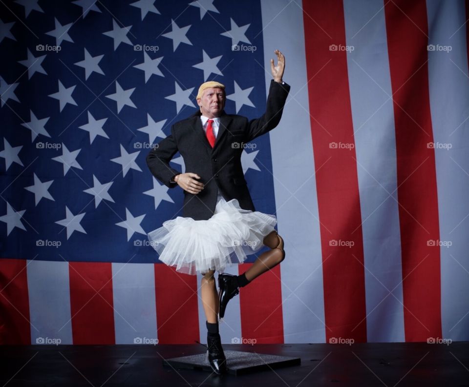 Donald trump in ballet tutu with us flag in background 