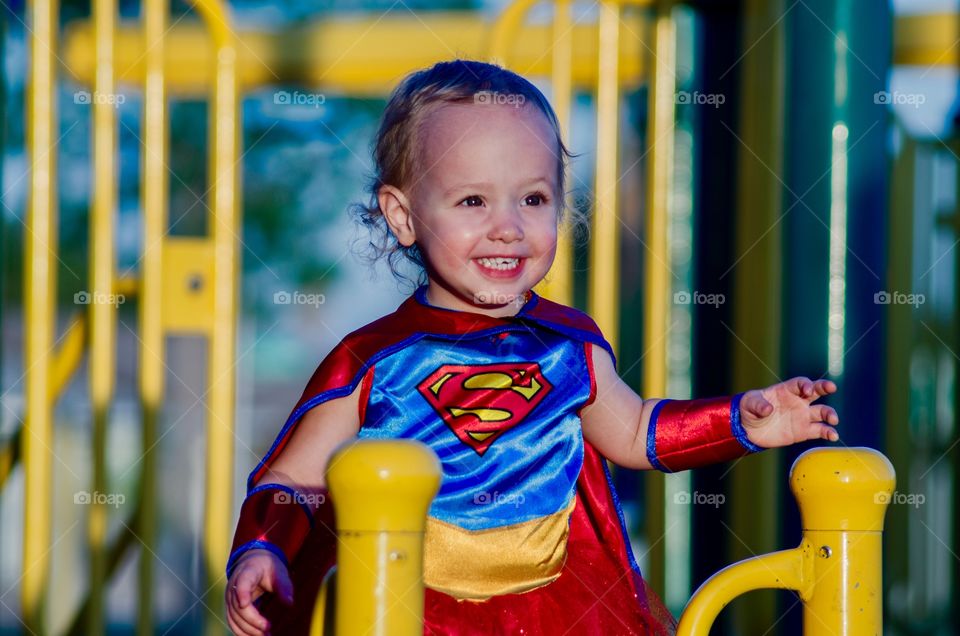 Portrait of baby girl wearing superhero costume