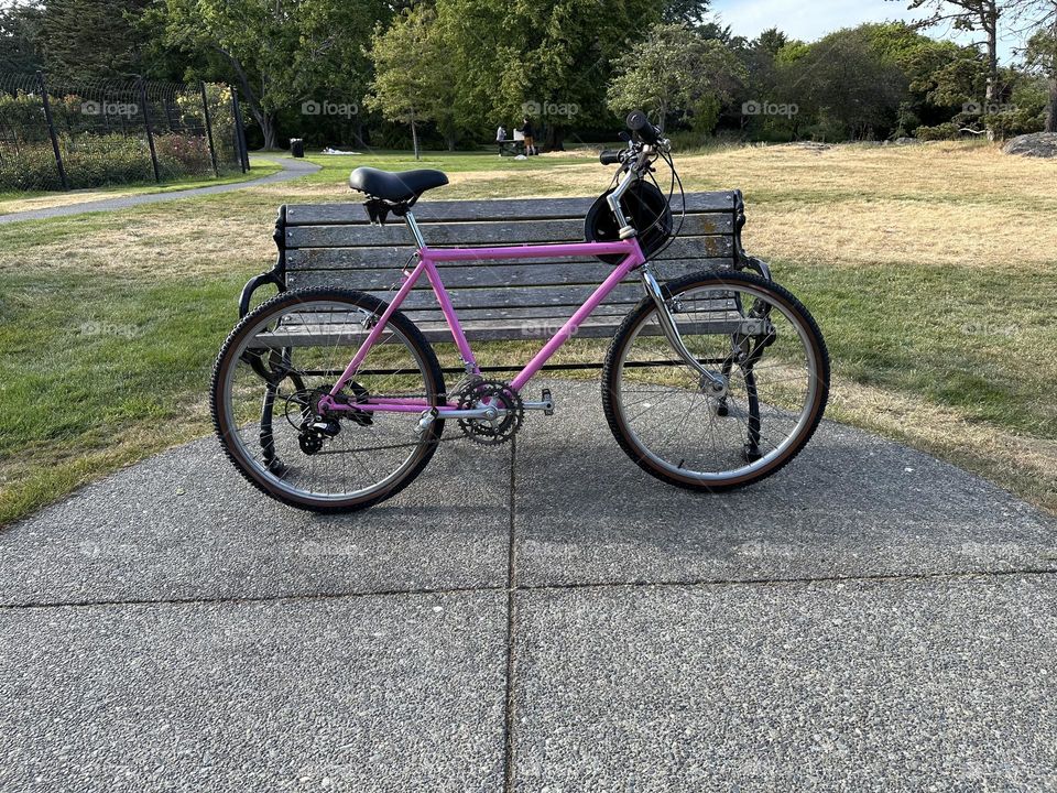 Bike left in front of a bench