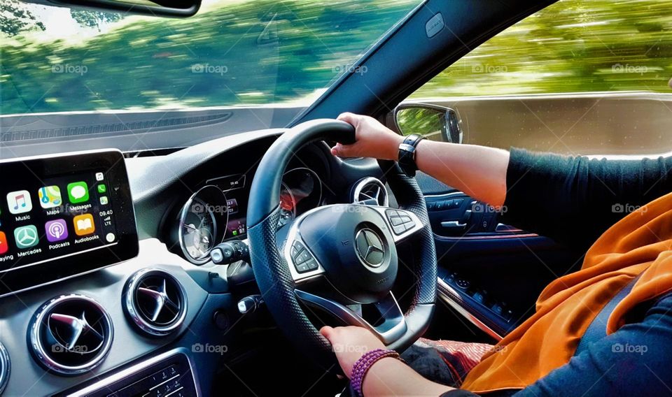 Regular driving on the road, sedan car steering cab view, outdoor speed view, full car dashboard, speedometer, odometer, audio display, intertaiment system, steering safety system, pleasant experiene,