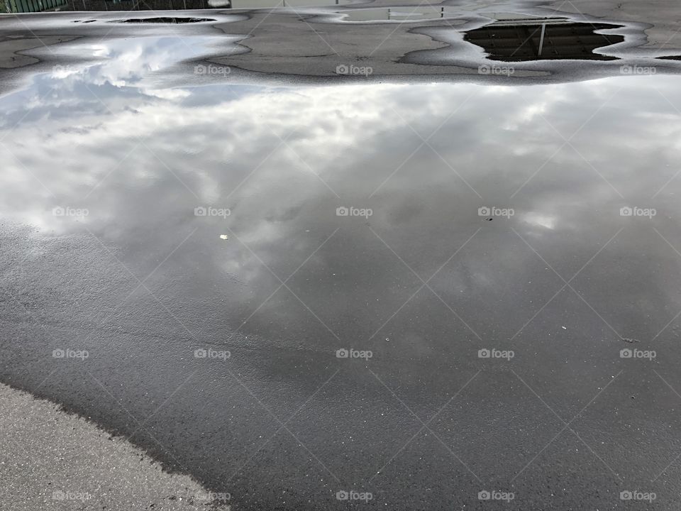 Clouds on puddle