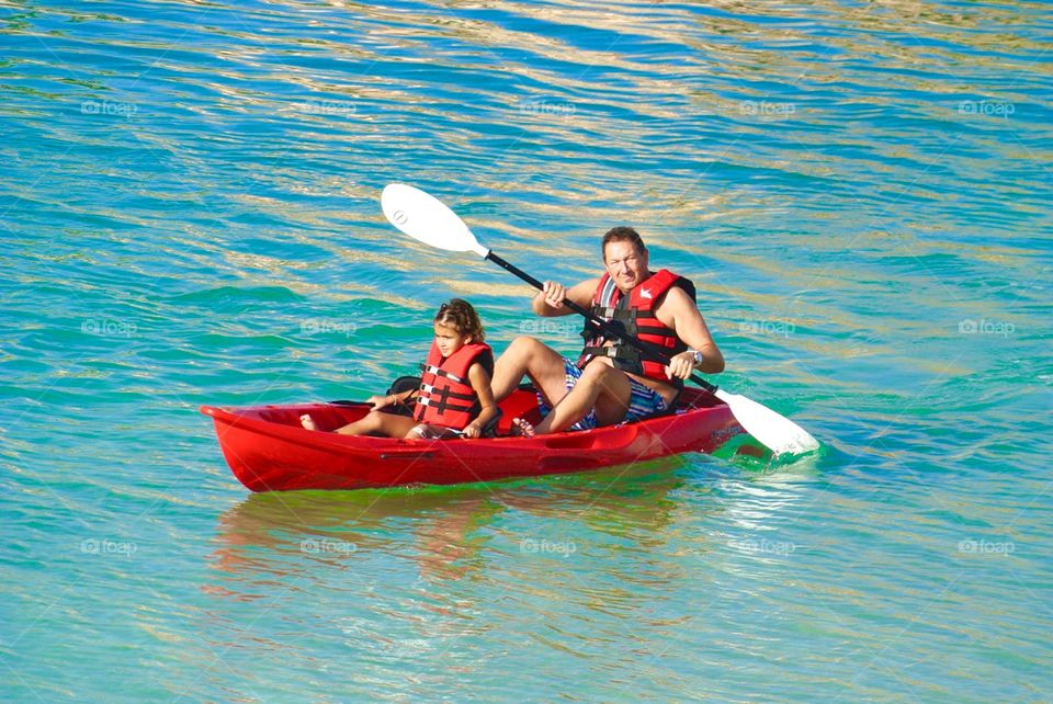 Father boat paddling with son
