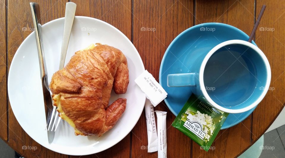 Simple breakfast with tea and croissants