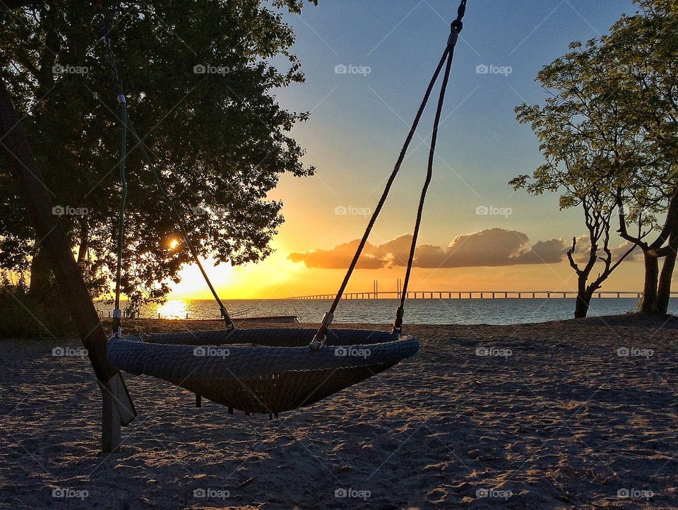 View of swing in sunset