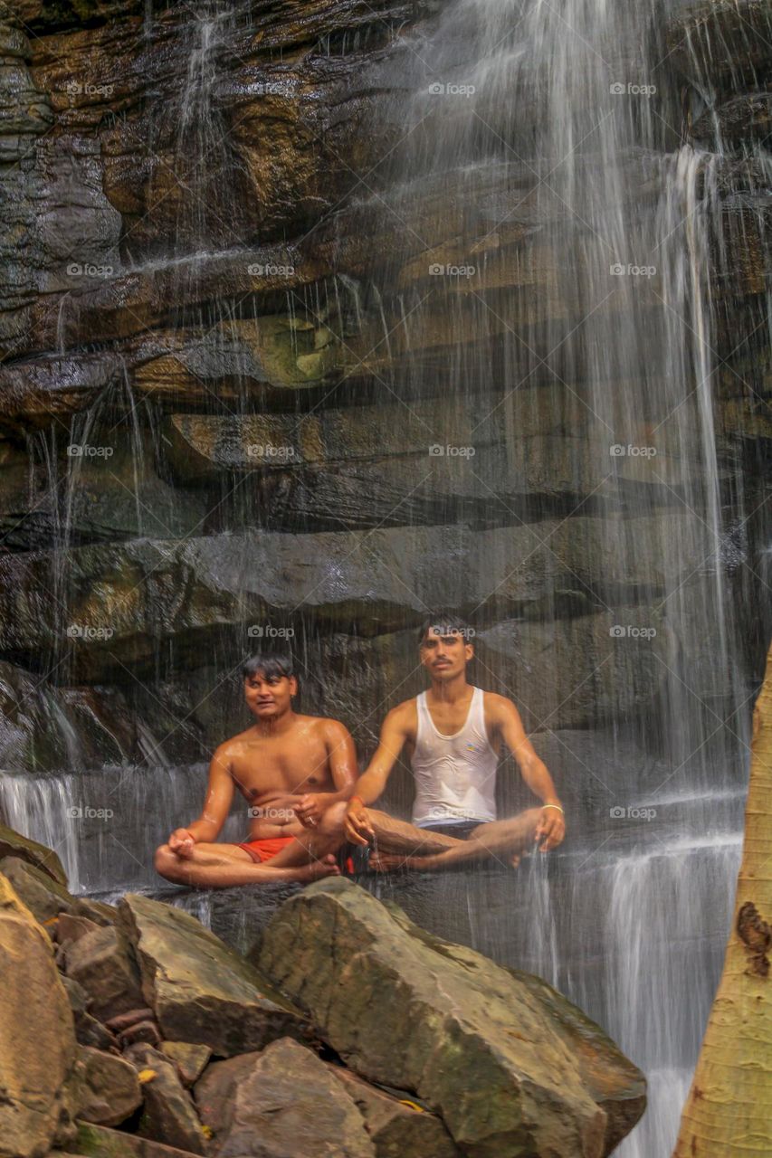 Bathing under the waterfall in summer