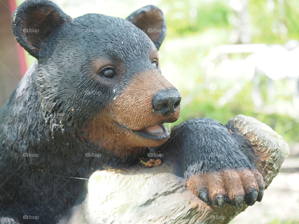 Artificial bear cub on a tree