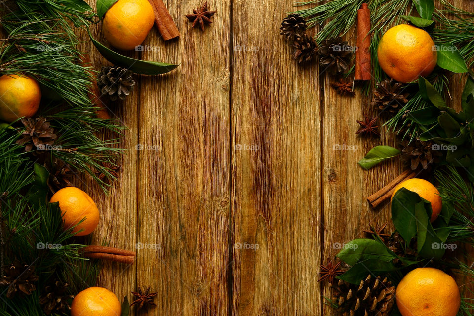 Christmas decoration, tangerines and spices wooden background.