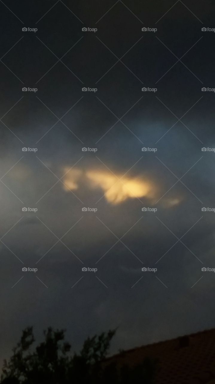 As the Storms Formed Around in the Sky A Golden Center As Blue Grey Clouds Surround