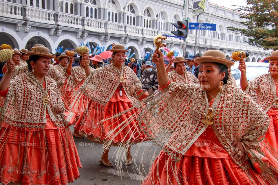 Bolivian people are dancing on the street during a festival