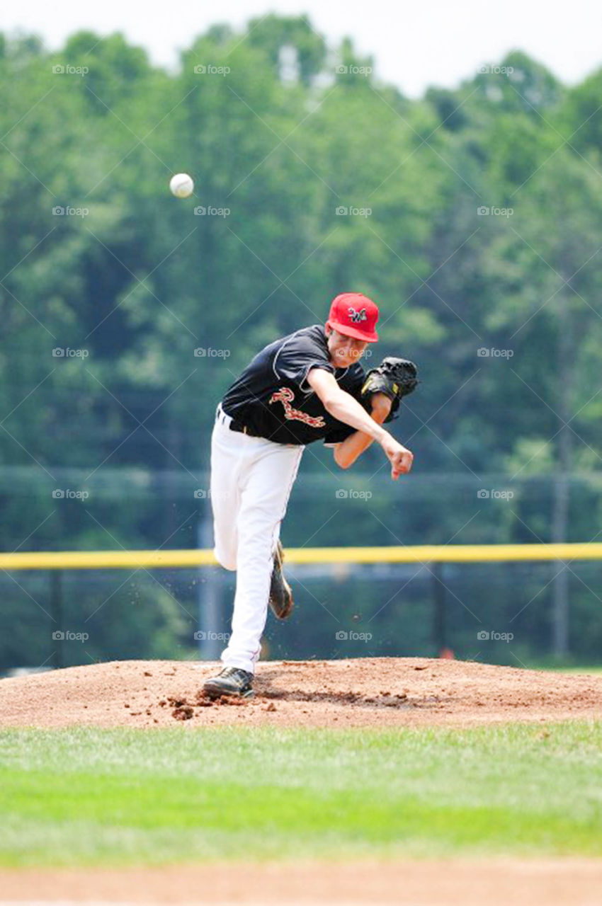 young baseball pitcher. young baseball pitcher  in motion on the mound