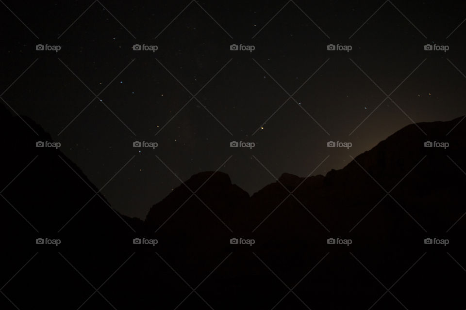 Stars behind mountains