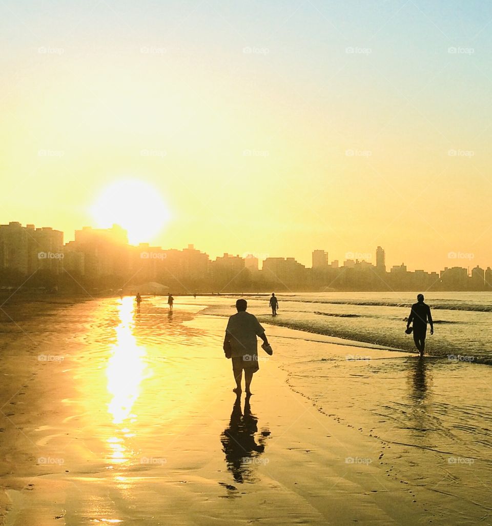 A golden world!  The sky reflecting on the beach sand in the coastal city of Santos, a paradise in Brazil. / Um mundo dourado! O céu refletindo na areia da praia na cidade litorâneas de Santos, um paraíso no Brasil. 