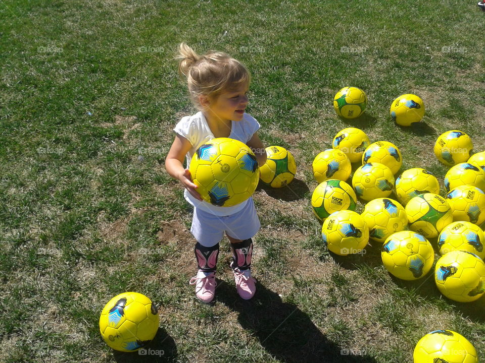 Little girl playing with soccer ball
