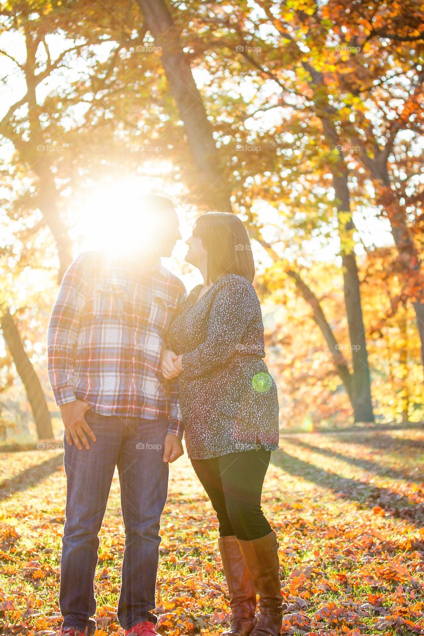 A couple embraces in the crisp, clean autumn air.