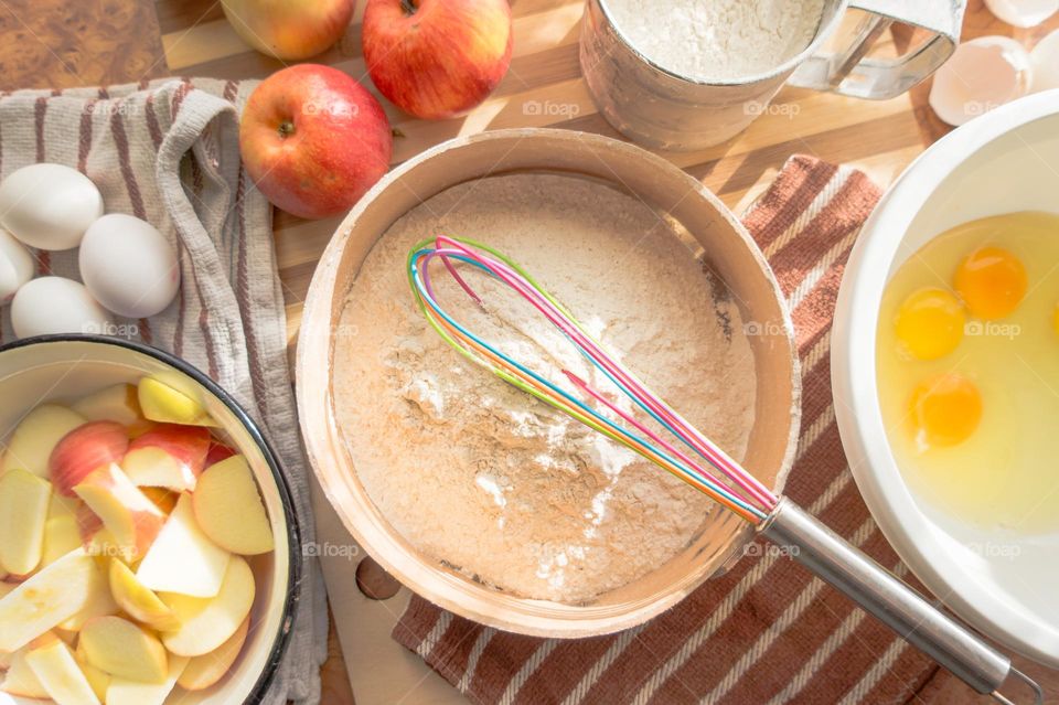 Making homemade puffed apple pie with eggs, sugar and flour.