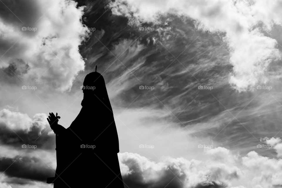 priest against a cloudy sky