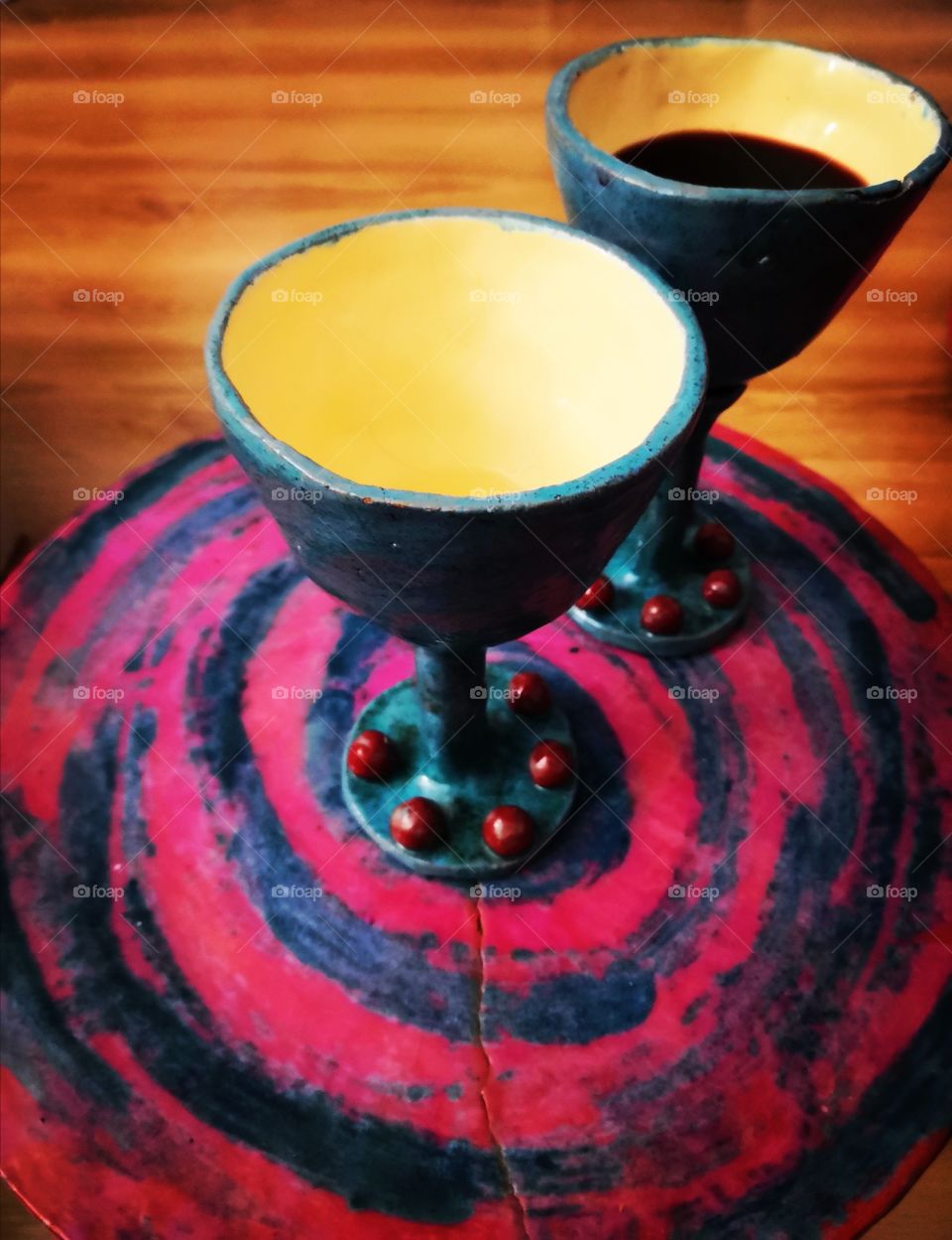 Ceramic glasses with red wine on ceramic table