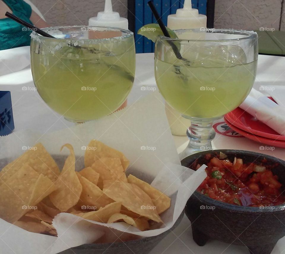 Frozen margaritas with chips and salsa.