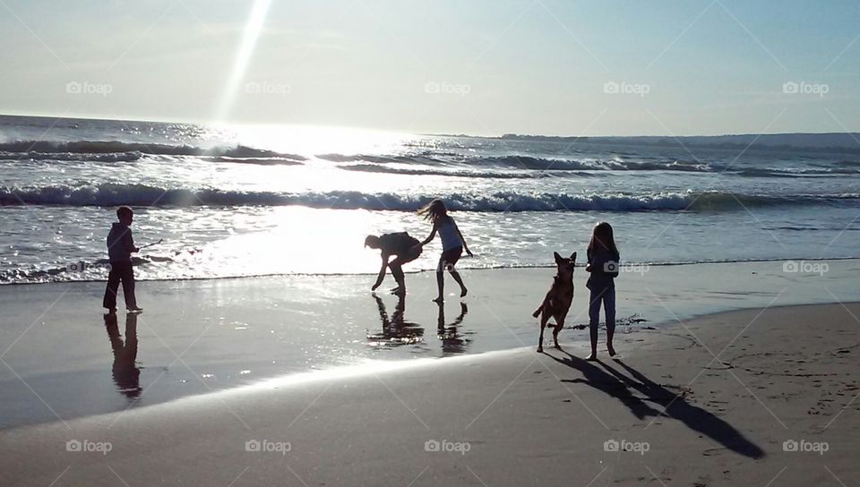 frolicking spring beach. playing in the California waves as the sun begins its decent 