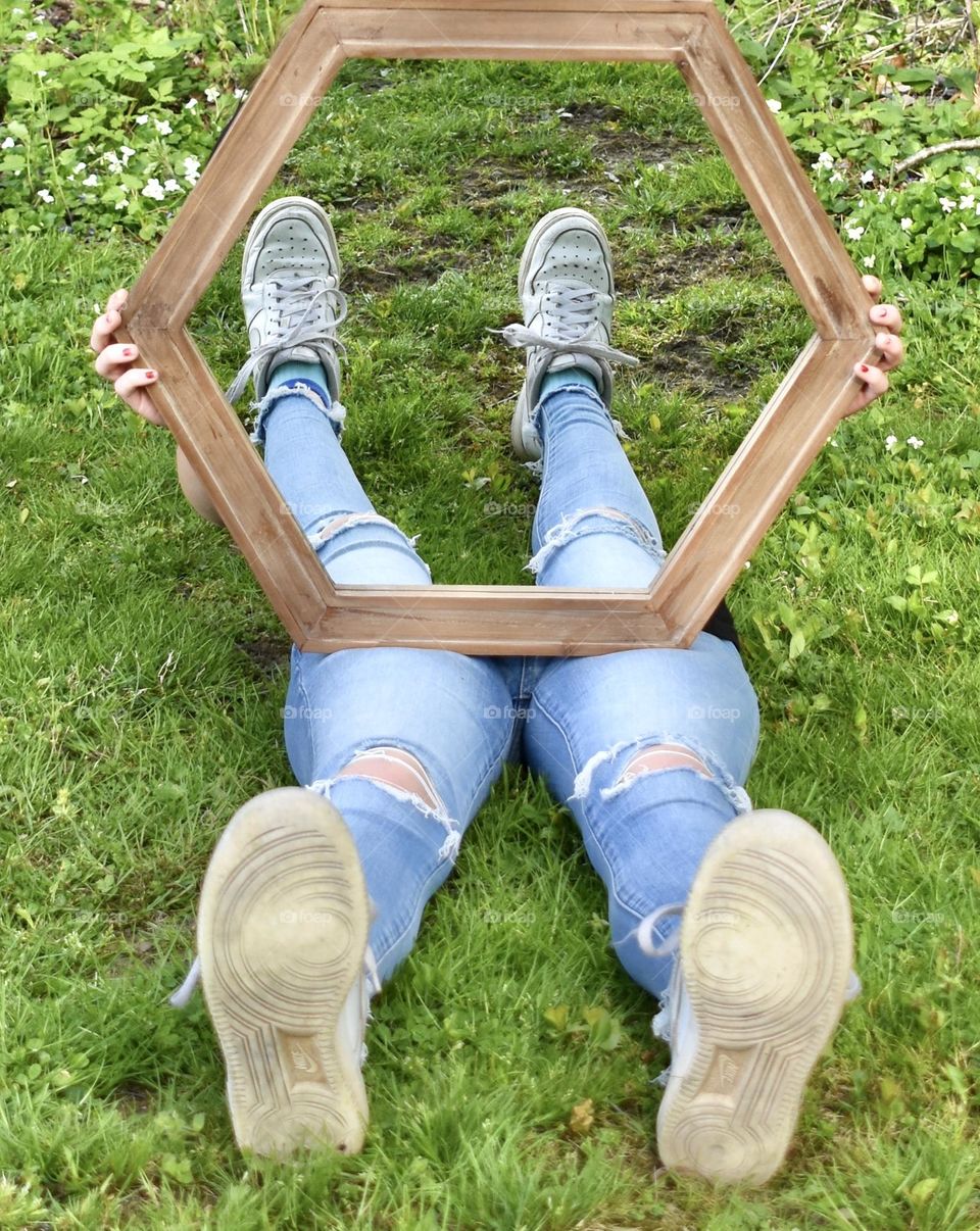 Reflection of girl sitting in grass 