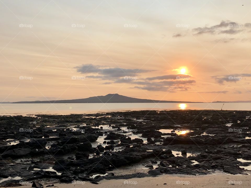 Sunrise over Rangitoto Island in Auckland, as seen from Takapuna Beach