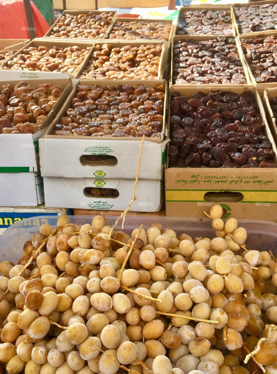 Dates in various forms; fresh frozen, dried and semi-dried at a morning market in Medina, Saudi Arabia
