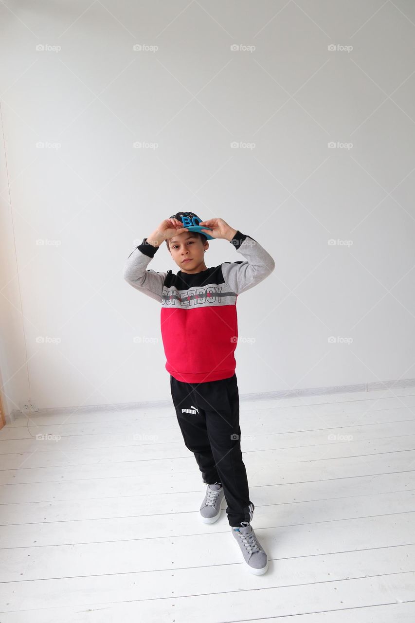 Boy holding a cap