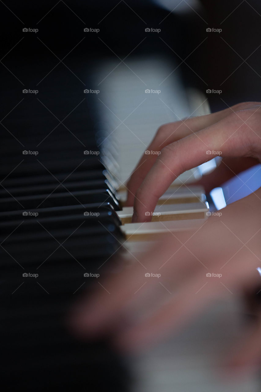 Skilled hands working on a piano.