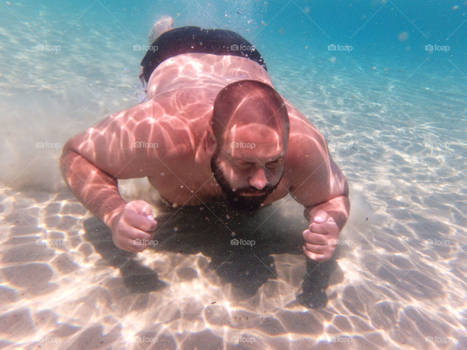 man snorkling in the sea. man snorkling in crystal clear waters