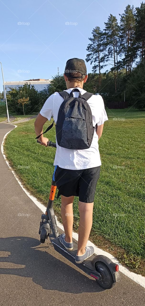 boy on a electric scooter, summer time