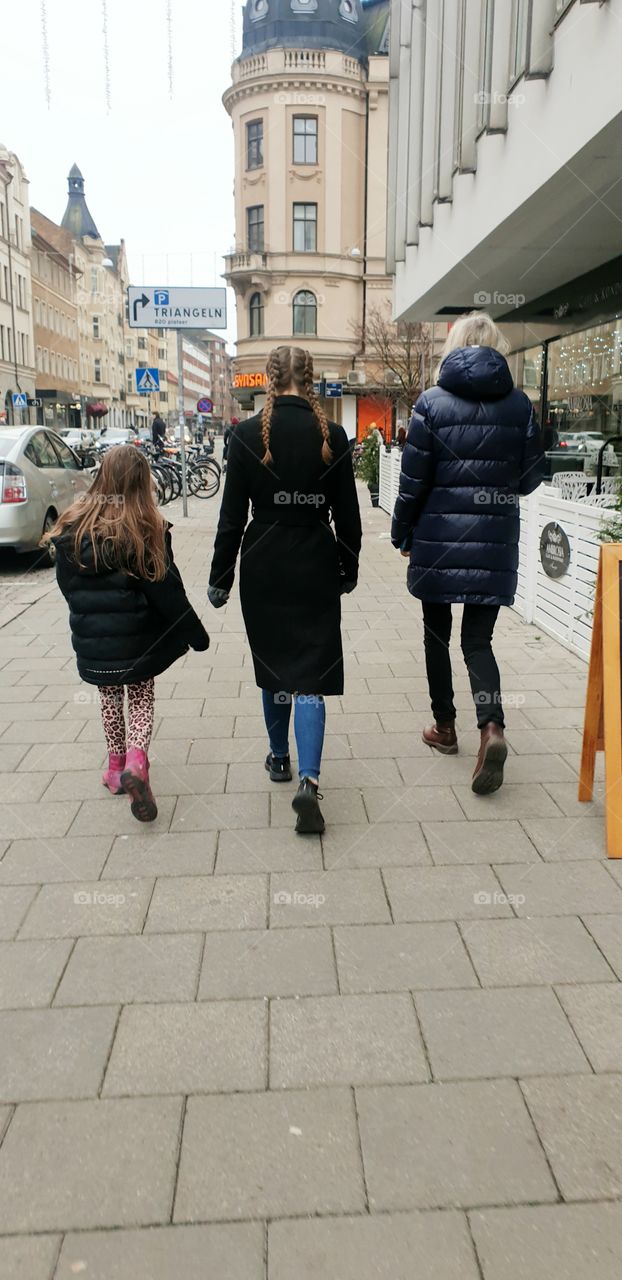 3 walking the sidewalk