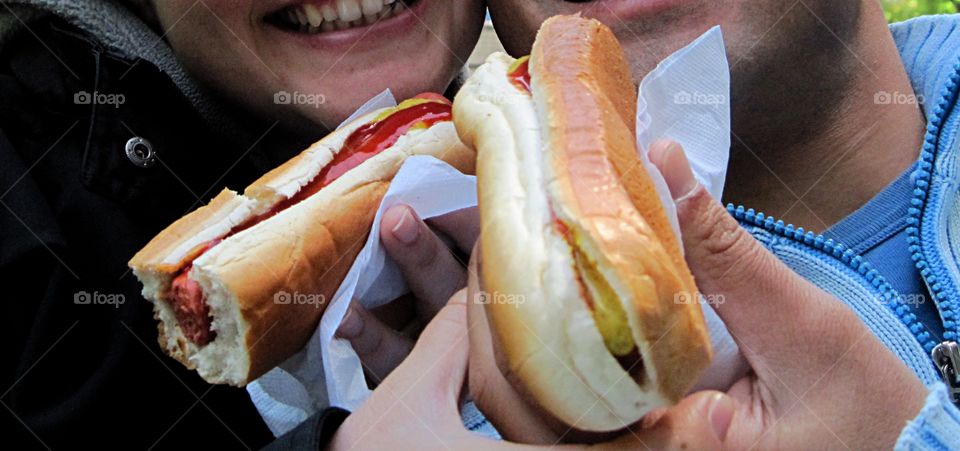 hot dogs hold by hands