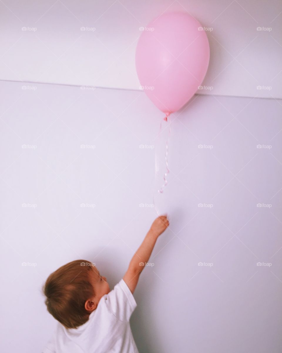 Child grabbing balloon